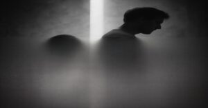 A black and white image of two silhouetted figures—one a boy, one a man—facing away from each other. The visual represents toxic masculinity in tech leadership and the emotional distance passed down between generations